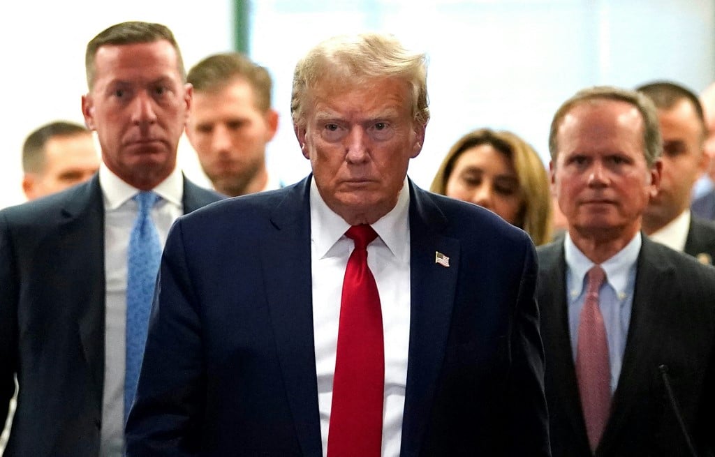 Former US President Donald Trump departs during a break in the civil fraud trial against the Trump Organization, at the New York State Supreme Court in New York City on December 7, 2023. Former US President Donald Trump was back in court on December 7, 2023, for his New York civil trial on fraud allegations, once again condemning the process as unfair. Trump, the frontrunner for the 2024 Republican presidential nomination, and his two eldest sons are accused of inflating the value of their real estate assets to receive more favorable bank loans and insurance terms. (Photo by TIMOTHY A. CLARY / AFP)