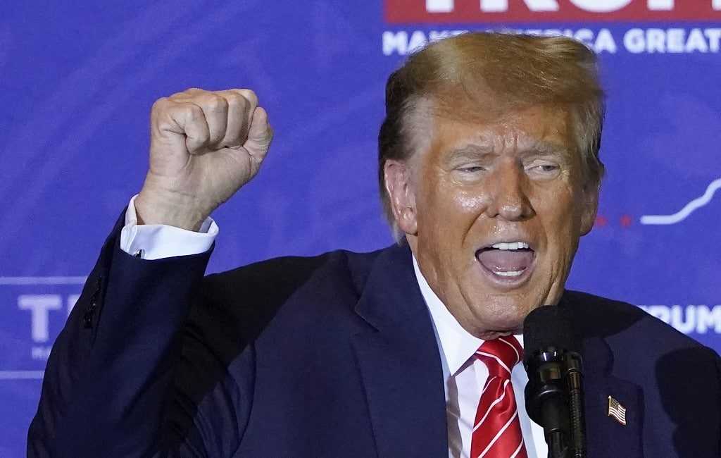 Republican presidential hopeful and former US President Donald Trump raises his fist as he speaks at a campaign event in Concord, New Hampshire, on January 19, 2024. (Photo by TIMOTHY A. CLARY / AFP)