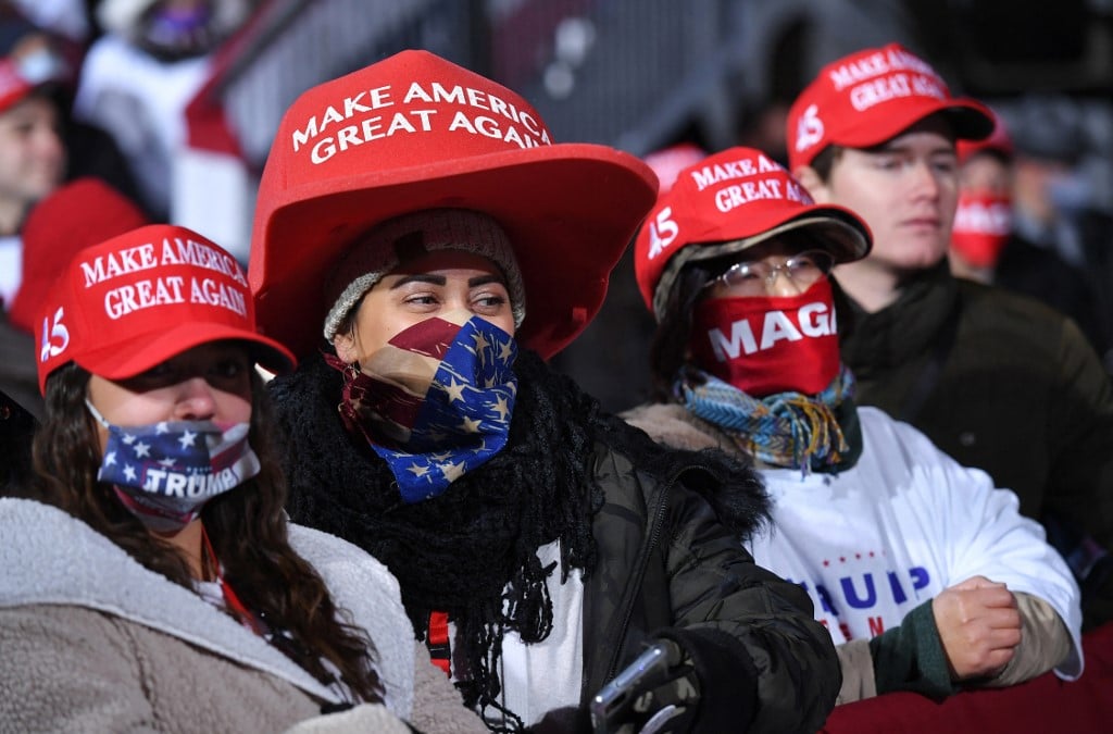 Supporters watch as US President Donald Trump speaks during a during a rally at Williamsport Regional Airport in Montoursville, Pennsylvania on October 31, 2020. (Photo by MANDEL NGAN / AFP)